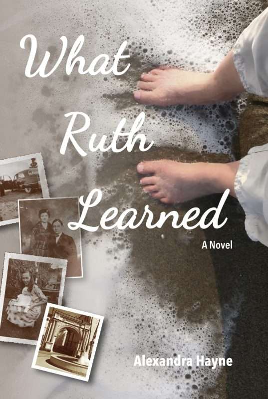 A book cover showing a pair of bare feet standing at the edge of ocean waves on wet sand. Foam from the surf spreads around the feet. Scattered vintage black‑and‑white photographs lie across the left side of the image, partially overlapping the sandy background. The title “What Ruth Learned” appears in large white script across the center, with the subtitle “A Novel” beneath it. At the bottom, the author’s name, “Alexandra Hayne,” is printed in white text.